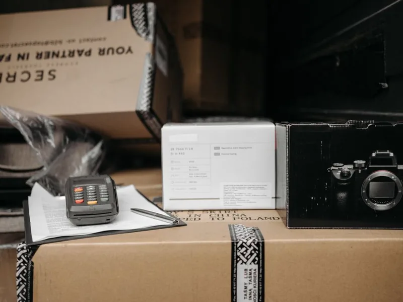 Assorted packages with camera equipment ready for shipment in an indoor setting.