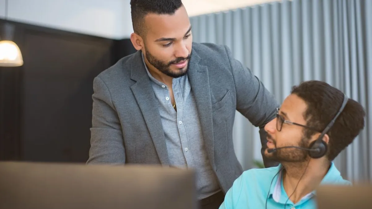 Two men collaborating in an office environment, fostering teamwork.